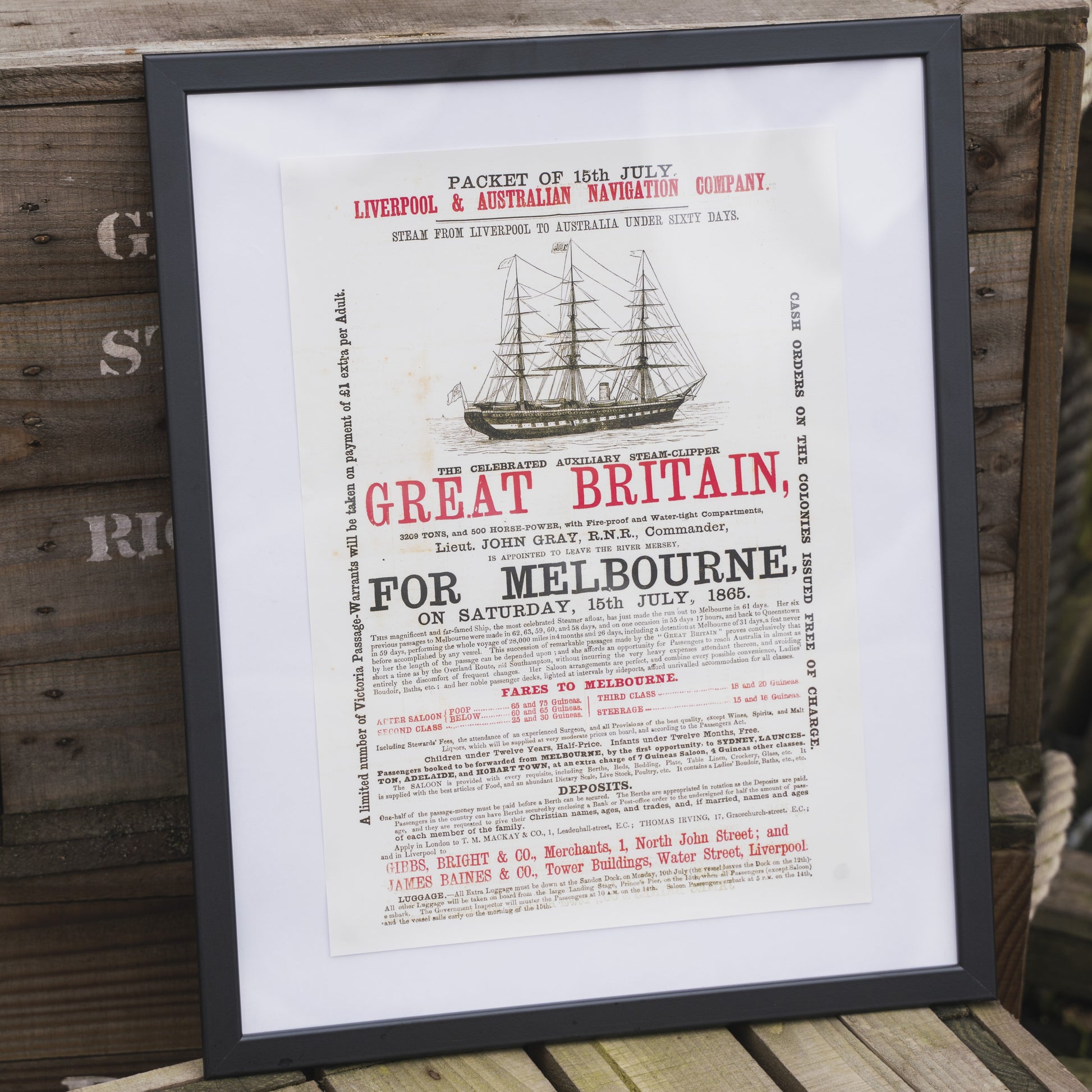 A framed print poster featuring a vintage advertisement for the SS Great Britain steamship with bold red and black text on a beige background.