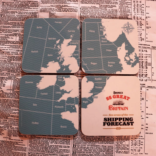 A set of four square melamine coasters with a map-based 'Shipping Forecast' design, displayed on a surface with a newspaper print background.