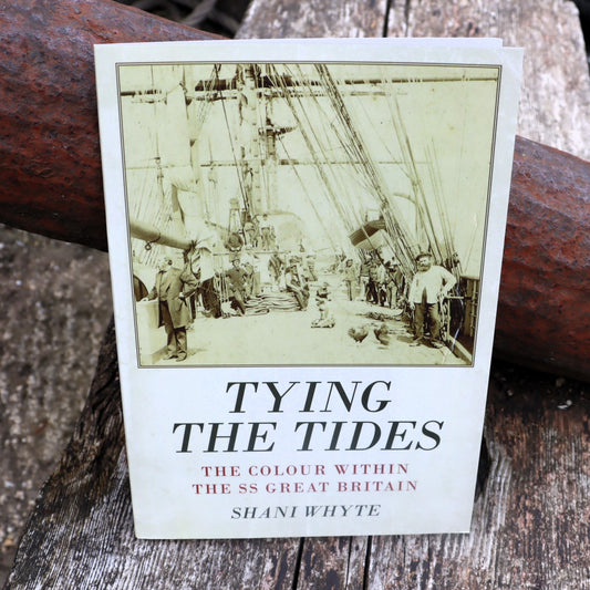 A book cover of 'Tying the Tides: The Colour within the SS Great Britain' featuring an old photograph of people onboard a ship, with the title and author name displayed.