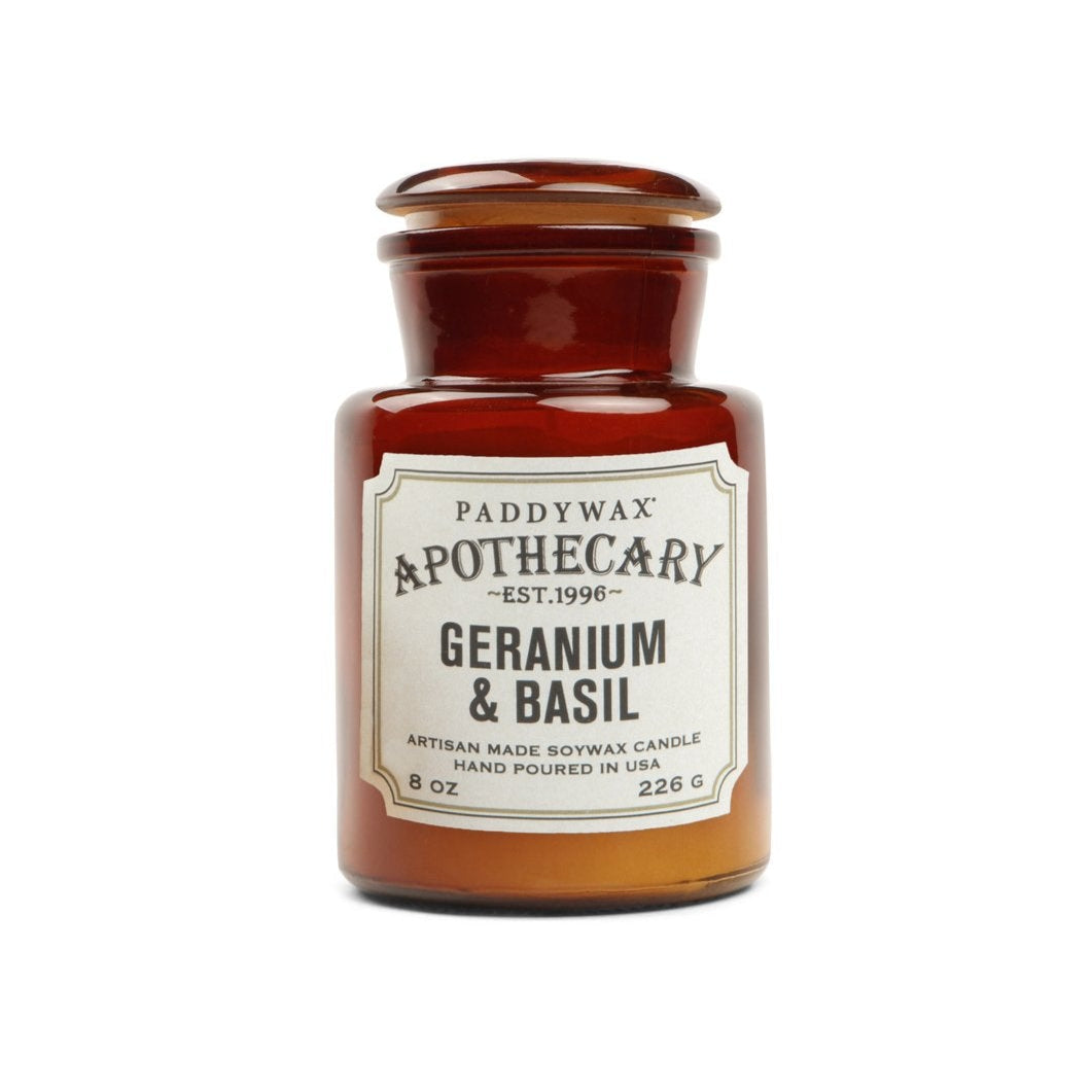 Paddywax Apothecary Geranium & Basil candle in a brown glass jar on a white background