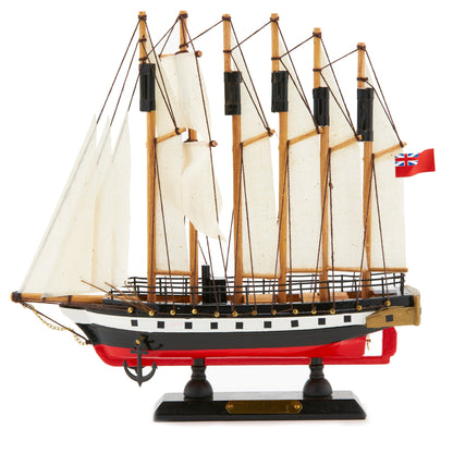 Model ship with white sails and a red base on a white background